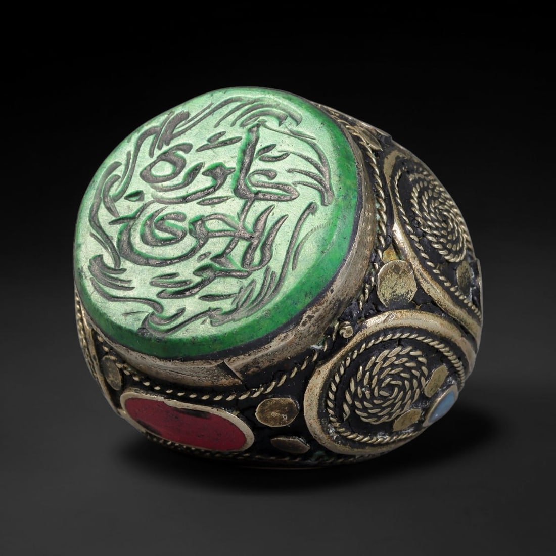 Vintage Islamic Handcrafted Silver Plated Calligraphic Talisman Statement Ring, 4BX: This vintage hand-wrought Islamic statement ring features a central engraved panel bearing traditional calligraphic detailing, set within an ornate silver-plated metal band. The mounting is enriched w