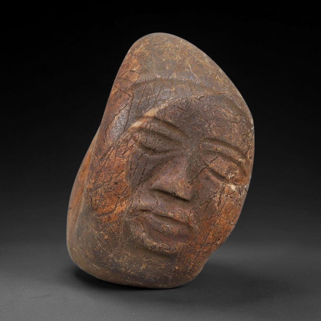 Ancient Medieval Near Eastern Stone Maskette (500-1000 CE), 82EJ: This antique stone maskette originates from medieval Near Eastern cultural tradition, produced for ceremonial and talismanic purposes. The stone shows natural earthy discoloration, surface weathering 