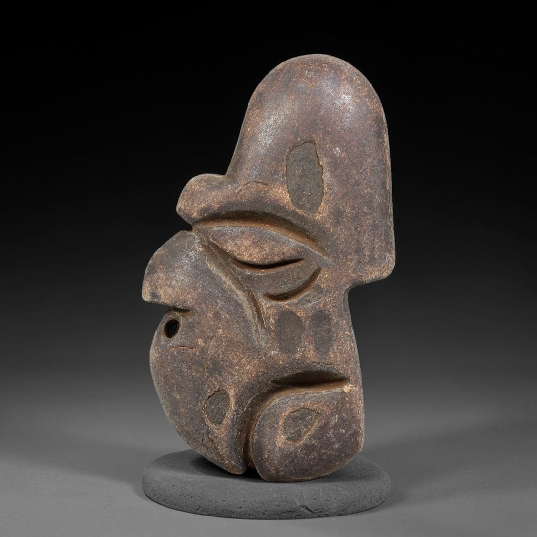 Ancient Medieval Near Eastern Stone Maskette (500-1000 CE), 71EJ: This antique stone maskette originates from medieval Near Eastern cultural tradition, produced for ceremonial and talismanic purposes. The stone shows natural earthy discoloration, surface weathering 