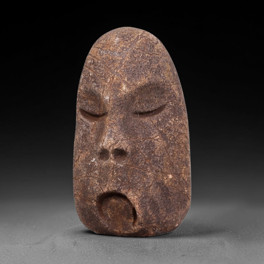 Ancient Medieval Mediterranean Hand Carved Stone Maskette Amulet, 36EJ: Miniature wearable sacred talisman hand hewn from natural soft stone, originating from Medieval Mediterranean cultural craft traditions. Small carved stone amulets were widespread personal artifacts a