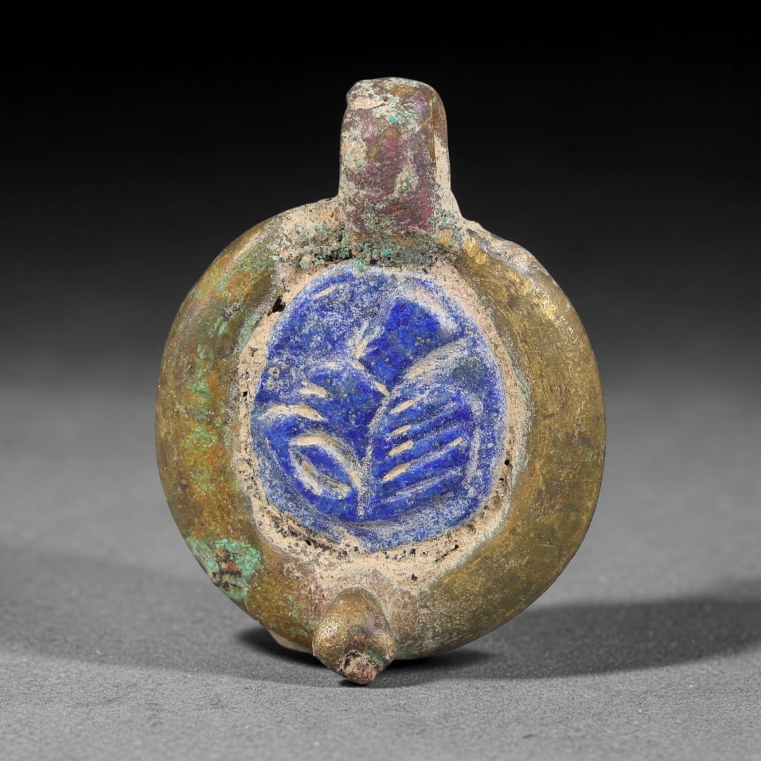 Ancient Medieval Byzantine Bronze Pendant With Stone Cameo (500-1200 CE), 69EH: This antique circular bronze pendant originates from medieval Byzantine cultural tradition, set with an inset carved stone cameo and made to serve as a wearable protective personal amulet. The bronze 