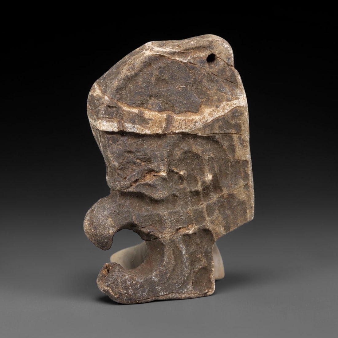 Ancient Medieval Near Eastern Stone Maskette (500-1000 CE), 67EJ: This antique stone maskette originates from medieval Near Eastern cultural tradition, produced for ceremonial and talismanic purposes. The stone shows natural earthy discoloration, surface weathering 