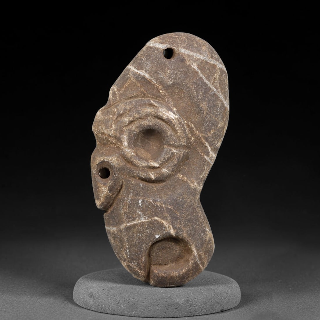 Ancient Medieval Near Eastern Stone Maskette (500-1000 CE), 69EJ: This antique stone maskette originates from medieval Near Eastern cultural tradition, produced for ceremonial and talismanic purposes. The stone shows natural earthy discoloration, surface weathering 