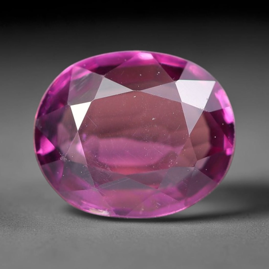 1.44ct Natural Tanzanian Rhodolite Grape Garnet Faceted Loose Gemstone, 7BE: This expertly faceted grape garnet, a scarce saturated purple-magenta rhodolite variant, features transparent crystal structure dotted with faint microscopic mineral specks within its precisely cut re