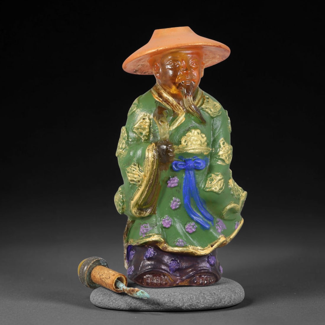 Vintage Chinese Liuli Glass Snuff Bottle - Scholar with Straw Hat, 56AS: This snuff bottle is moulded from translucent amber liuli glass, shaped as a robed scholar wearing a straw hat. The green robe features raised gilded cloud patterns accented with hand-painted purple f