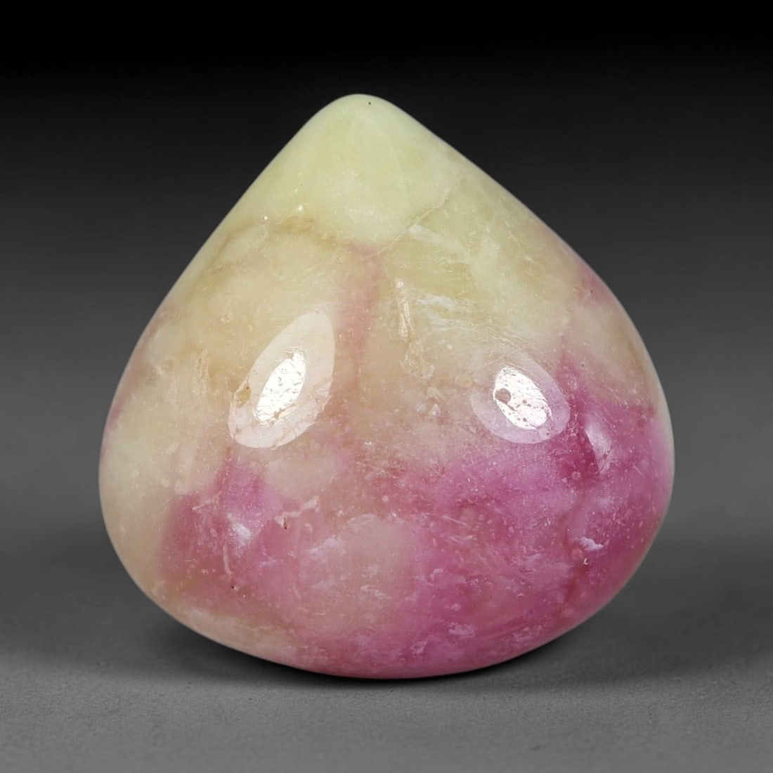 18.60 Carats Natural Mozambique Bicolor Ruby Loose Gemstone, 48FG: This natural Mozambique bicolor ruby cabochon holds dimension measurements of 15.9x15.5x7.8mm, displaying soft swirled intermix of rich pink and pale creamy mineral tones that blend seamlessly across 