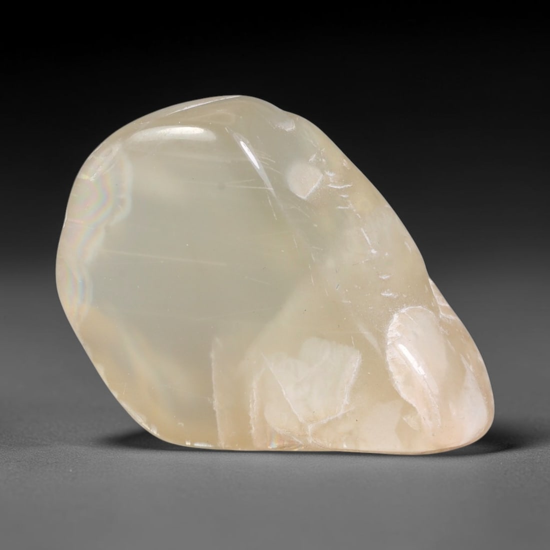 73ct Natural Ceylon Pale Cream White Moonstone Rough, 65AH: This smooth weathered moonstone rough carries soft pale cream white translucency with subtle internal silvery adularescent shimmer locked within its naturally tumbled surface, fine faint mineral veini