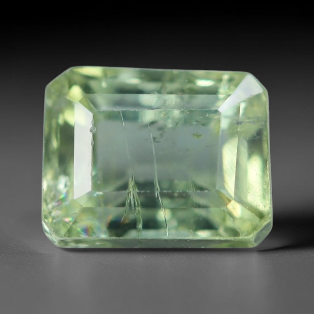 1.90 Carats Natural Mozambique Sage Green Tourmaline Loose Gemstone, 44AK: This transparent Mozambique tourmaline displays a delicate light sage green shade, featuring subtle natural fine fissures and scattered tiny mineral micro-inclusions within its crystal matrix, measure