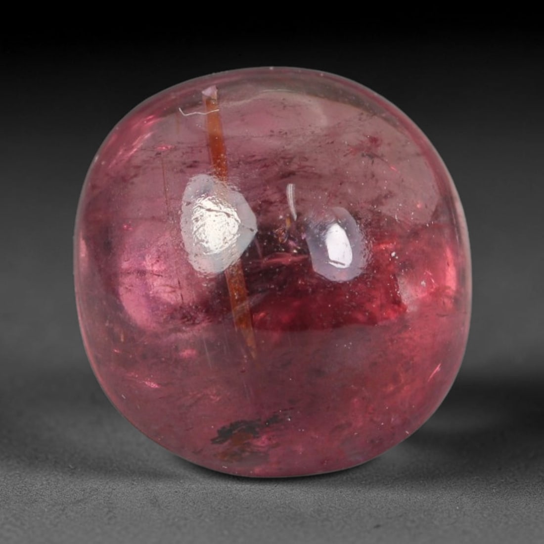 3.71ct Natural Brazilian Rubellite Tourmaline Cabochon Loose Gemstone, 2BC: This smoothly polished cabochon rubellite tourmaline features layered saturated pink-red body saturation with dense natural crystalline mineral flecks and fine internal fracture markings concentrated 