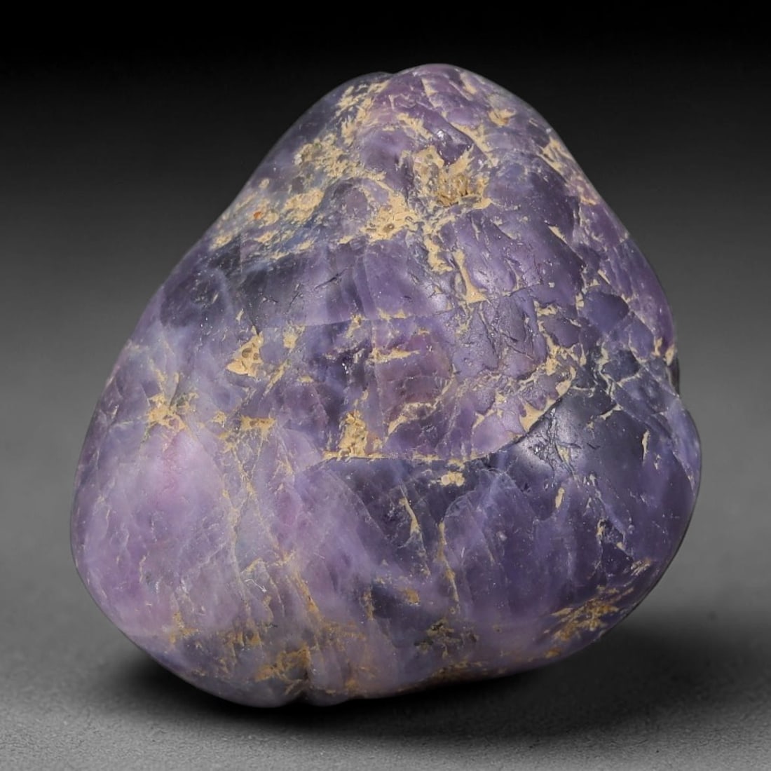 76.44ct Natural Unheated Sri Lankan Purplish Blue Sapphire Rough, 44FC: This natural corundum rough is an unheated purplish blue sapphire sourced from Sri Lankan alluvial gem deposits, featuring an irregular natural native form with residual pale yellow-brown mineral matr