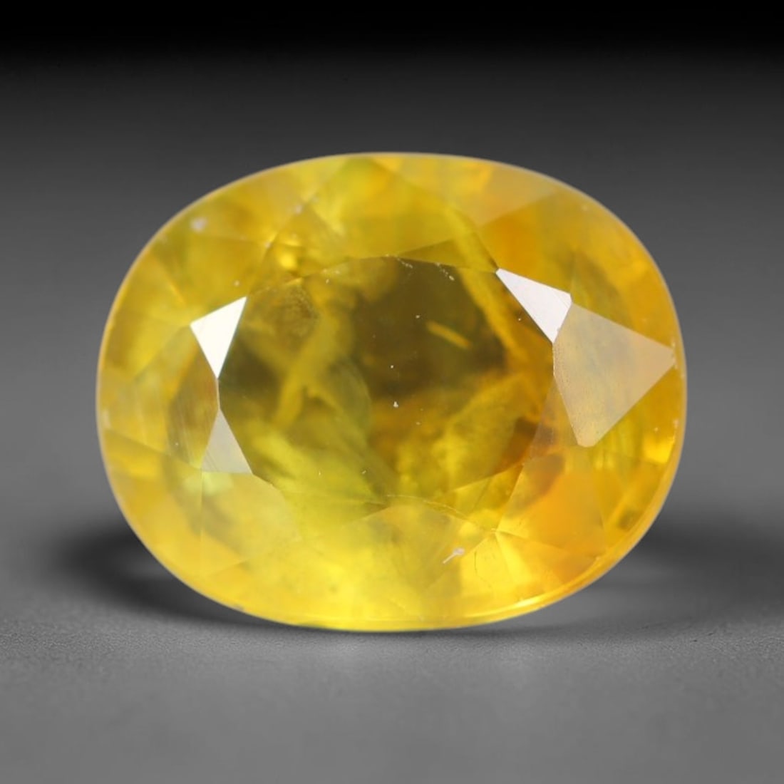 1.32ct Natural Ceylon Vivid Golden Yellow Sapphire Loose Gemstone, 68BC: This fully finished polished yellow sapphire boasts rich warm golden yellow body saturation, with faint microscopic mineral specks distributed within its crystal interior, measured at calibrated dimen