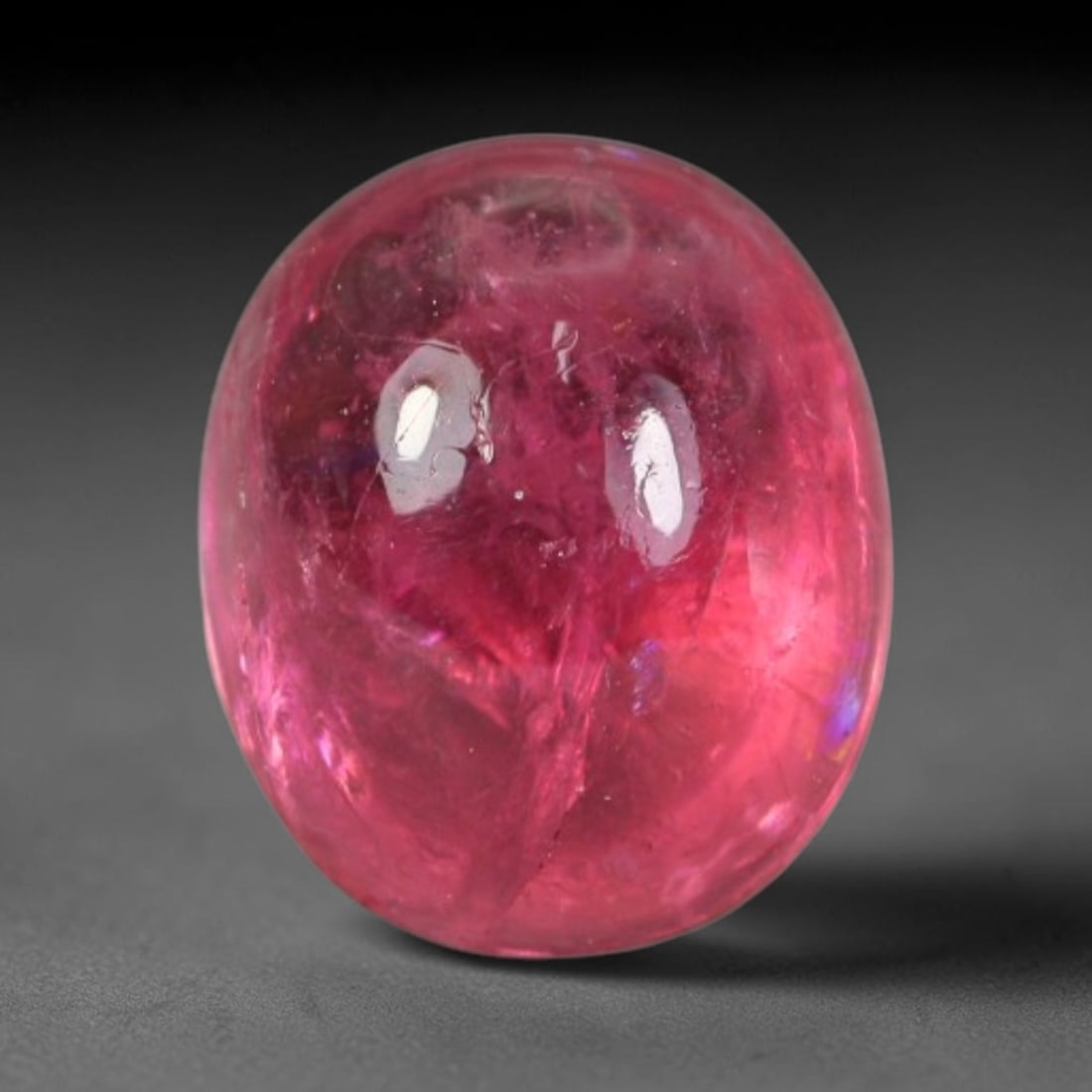 1.47ct Natural Brazilian Rubellite Tourmaline Cabochon Loose Gemstone, 42BC: This smoothly polished cabochon rubellite tourmaline features layered saturated pink-red body saturation with dense natural crystalline mineral flecks and fine internal fracture markings concentrated 