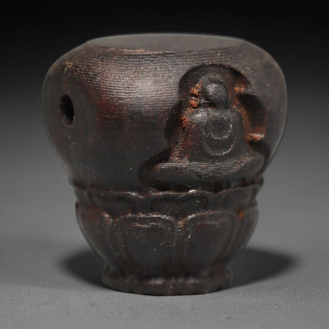 A Chinese Agar Wood Carved Head Art Bead, 33BX: Chinese agar wood head-form art bead measuring 22 x 20 mm. Detailed sculpted facial features cover the exterior surface, with a continuous central bore designed for stringing within beaded strands. Th