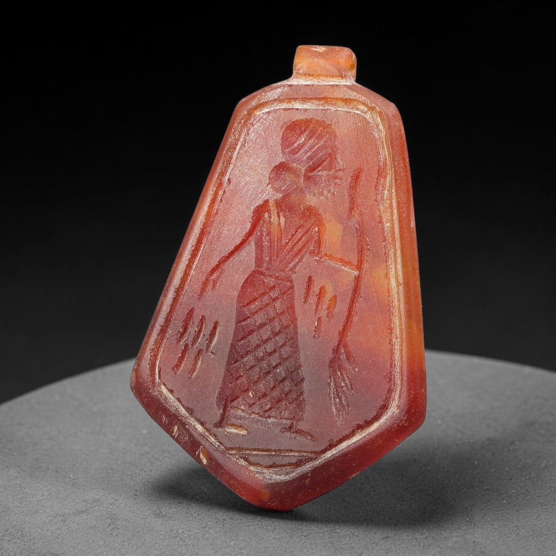 Vintage Natural Carnelian Agate Revival Indo-Persian Glyptic Figural Talisman Amulet Plaque, 27FL: This vintage talisman pendant plaque is skillfully carved from natural banded carnelian agate, crafted in a style referencing ancient Indo-Persian glyptic art traditions. The face bears detailed relie