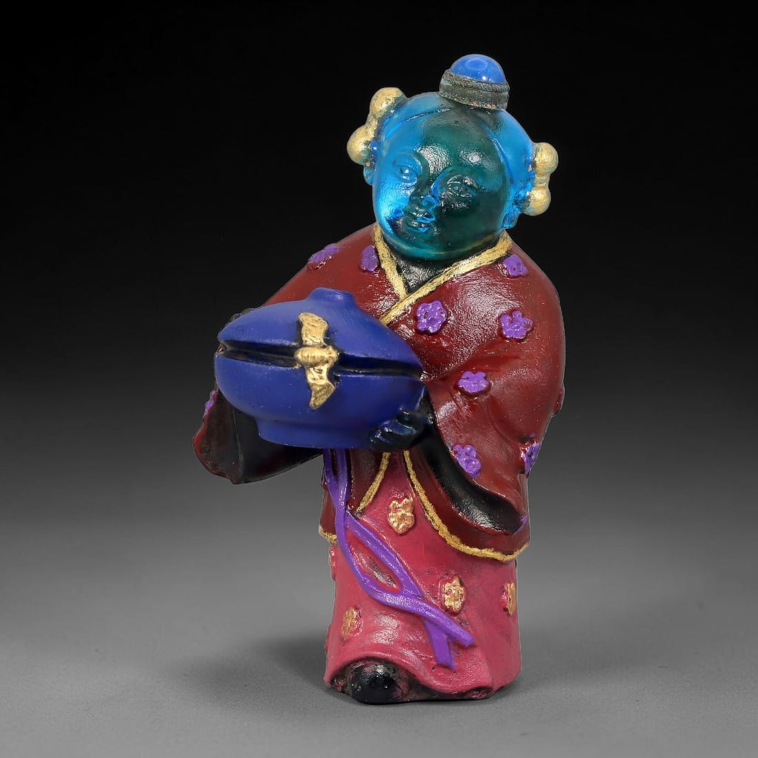 Vintage Chinese Liuli Glass Snuff Bottle - Girl Holding Treasure Censer, 34AS: This snuff bottle is moulded from translucent blue liuli glass for the head, shaped as a young girl holding a covered censer with gilded fittings. Her red traditional robe is hand-painted with purple 