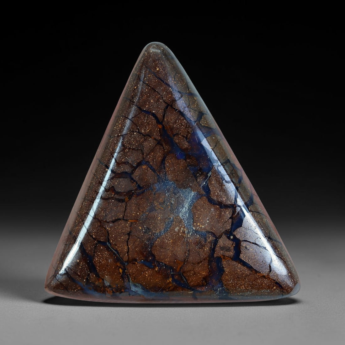 29.16ct Natural Australian Queensland Matrix Boulder Opal Cabochon, 25AV: Hand polished symmetrical smooth triangular cabochon crafted from natural Queensland matrix boulder opal, featuring fine speckled warm brown ironstone host rock crisscrossed with thick branching deep 