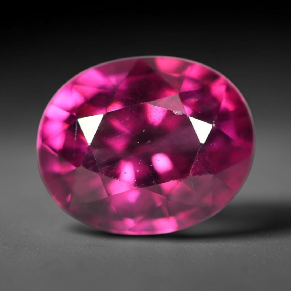 1.30ct Natural Tanzanian Rhodolite Garnet Loose Gemstone, 5BW: This natural rhodolite garnet originates from Tanzania, featuring well finished faceting that enhances light performance within the transparent crystal. Dimensions measure 7x5.6x3.9mm, fully polished 