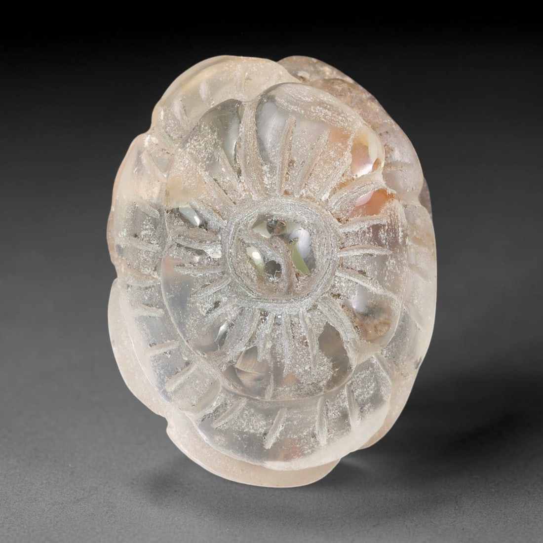 Natural Brazilian Phantom Quartz Hand Carved Floral Gemstone, 96BQ: This hand-carved floral specimen is crafted from natural phantom quartz. Intricate layered floral detailing wraps across the stone's surface, while translucent quartz matrix reveals subtle internal ph