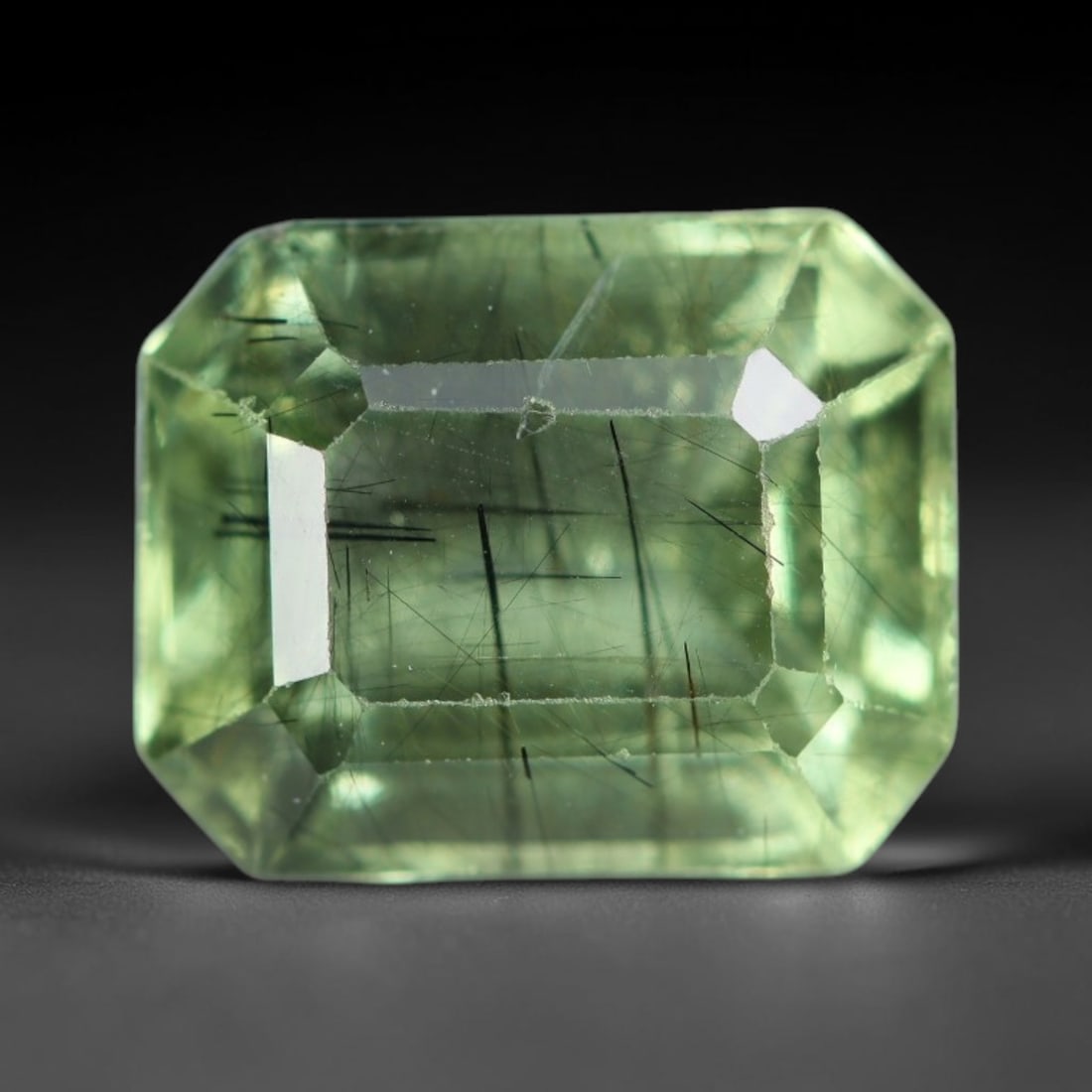3.27 Carats Natural Pakistani Olive Green Rutilated Peridot Loose Gemstone, 83AH: This translucent peridot displays soft olive green base tone intersected by prominent thin dark needle-like rutile inclusions that create striking linear internal patterns, measured at 9.4x7.5x5.3mm. 