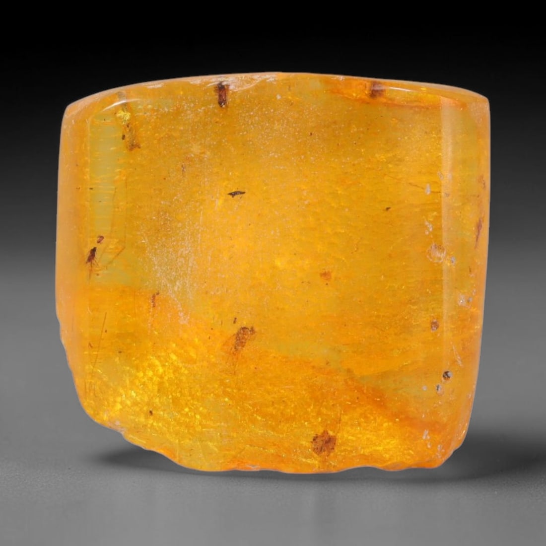 16.84ct Natural Baltic Polished Loose Freeform Amber Gemstone, 37AT: This smoothly polished freeform amber piece carries warm translucent organic clarity with fine natural fossil flecks and tiny mineral inclusions suspended throughout its 22x20mm flowing unstructured s