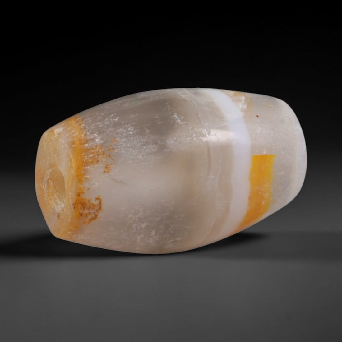 Ancient Akkadian Civilization Banded Agate Barrel Bead (2334-2154 BCE), 100AC: This antique banded agate barrel bead originates from the Akkadian Civilization, a Mesopotamian culture that inherited and expanded Sumerian agate bead carving traditions for royal burial goods and in
