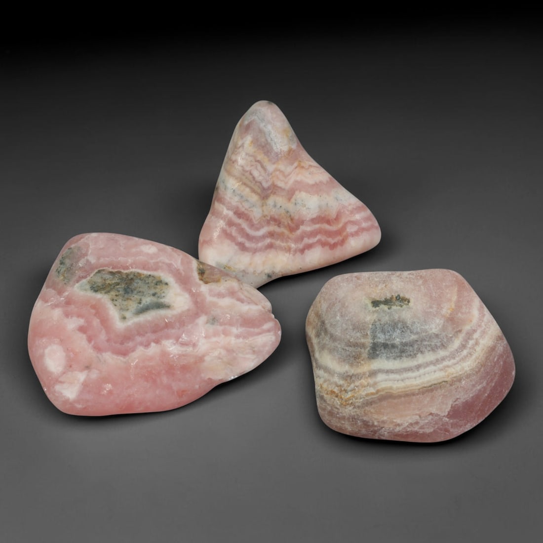 57ct 3pcs Natural Argentine Rhodochrosite Banded Tumbled Rough Set, 15FD: This listing features three individual tumbled rhodochrosite rough pieces sourced from Argentina Capillitas deposits, each showcasing distinct layered banding of soft rose pink, cream white and pale t