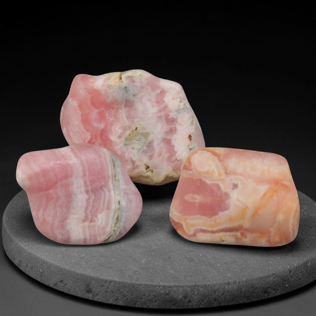 60ct 3pcs Natural Argentine Rhodochrosite Banded Tumbled Rough Set, 10FD: This listing features three individual tumbled rhodochrosite rough pieces sourced from Argentina Capillitas deposits, each showcasing distinct layered banding of soft rose pink, cream white and pale t