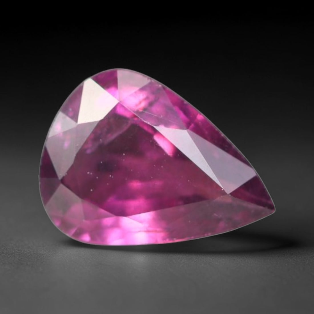 1.25ct Natural Tanzanian Rhodolite Grape Garnet Faceted Loose Gemstone, 100BA: This expertly faceted grape garnet, a scarce saturated purple-magenta rhodolite variant, features transparent crystal structure dotted with faint microscopic mineral specks within its precisely cut re