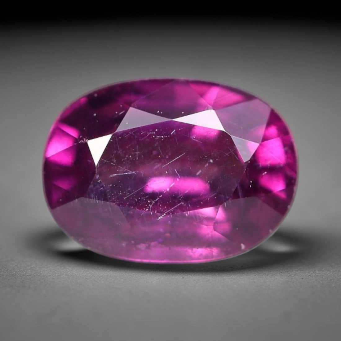 1.27ct Natural Tanzanian Rhodolite Grape Garnet Faceted Loose Gemstone, 98BF: This expertly faceted grape garnet, a scarce saturated purple-magenta rhodolite variant, features transparent crystal structure dotted with faint microscopic mineral specks within its precisely cut re