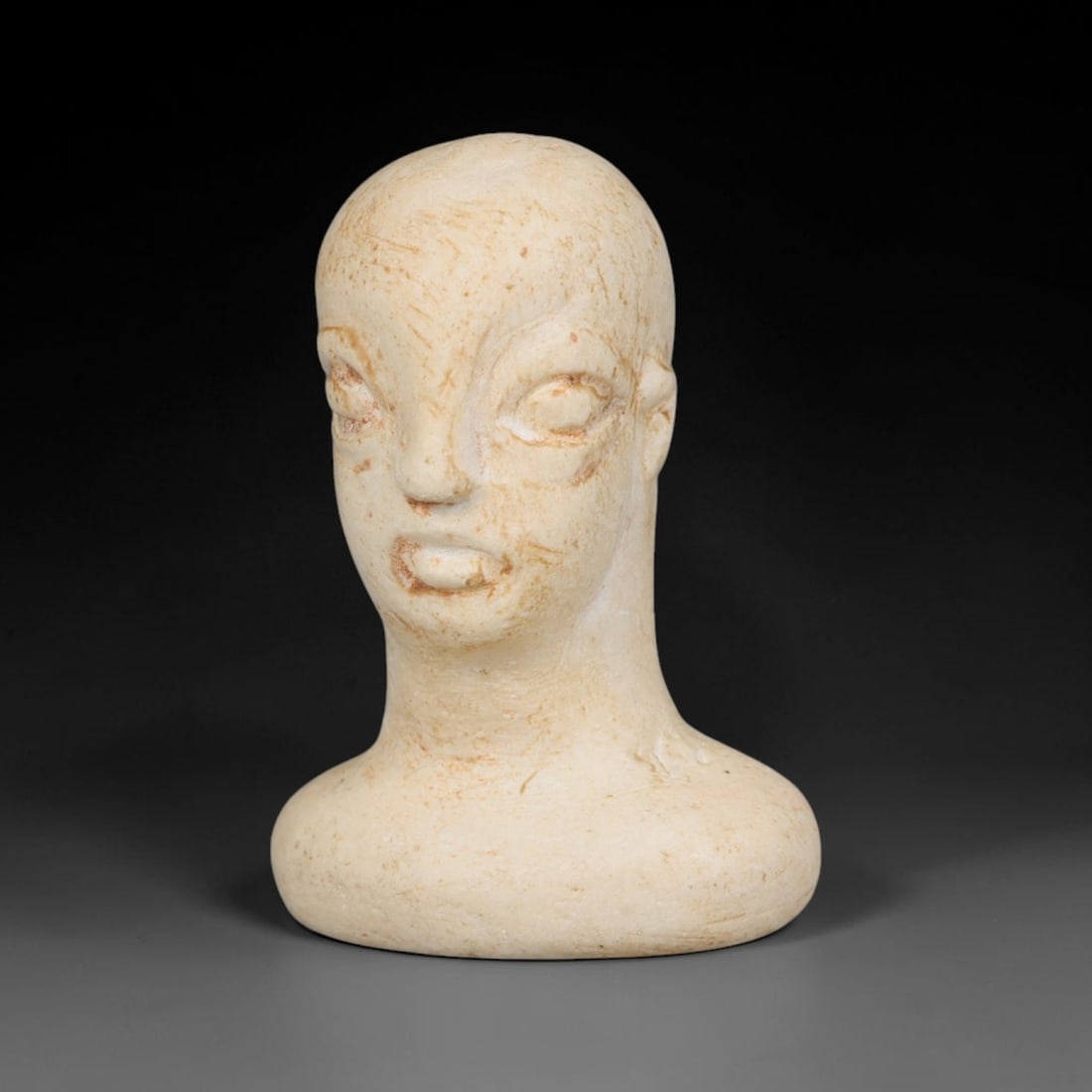 Ancient Bactrian Marble Idol Head (250 BCE-200 CE), 8EF: This carved pale marble idol head originates from Greco-Bactrian Culture, a significant Silk Road civilization blending Hellenistic and Central Asian artistic traditions. The simplified facial feature