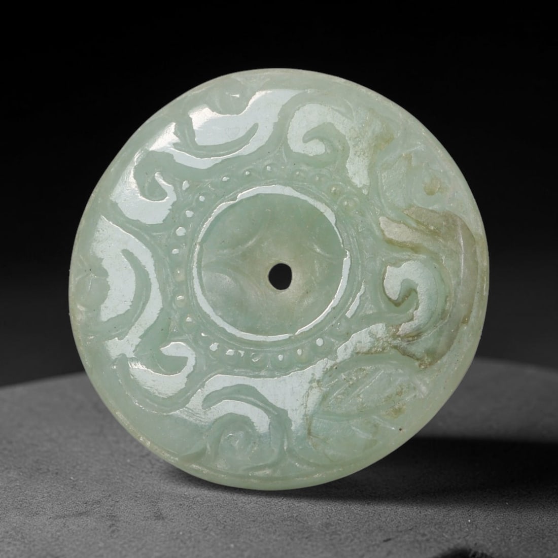 Natural Burmese Type A Jadeite Jade Carved Disc Pendant, 41BP: Artisan hand-carved untreated Burmese Type A jadeite jade circular disc pendant with a 27 mm diameter. The surface is adorned with detailed traditional relief carving finished with a smooth polished s