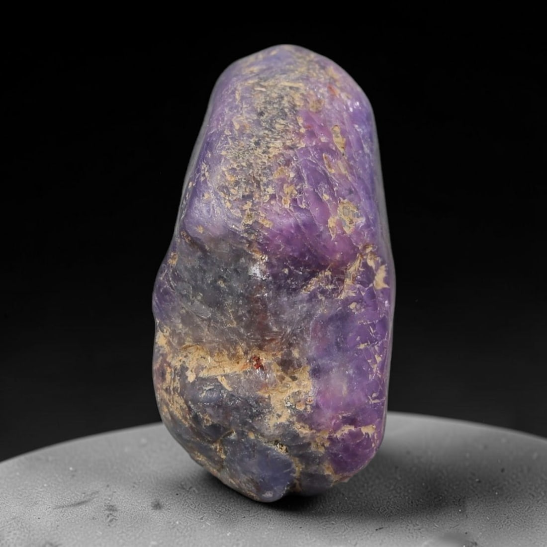 25.75ct Natural Unheated Sri Lankan Purplish Blue Sapphire Rough, 58FC: This natural corundum rough is an unheated purplish blue sapphire sourced from Sri Lankan alluvial gem deposits, featuring an irregular natural native form with residual pale yellow-brown mineral matr