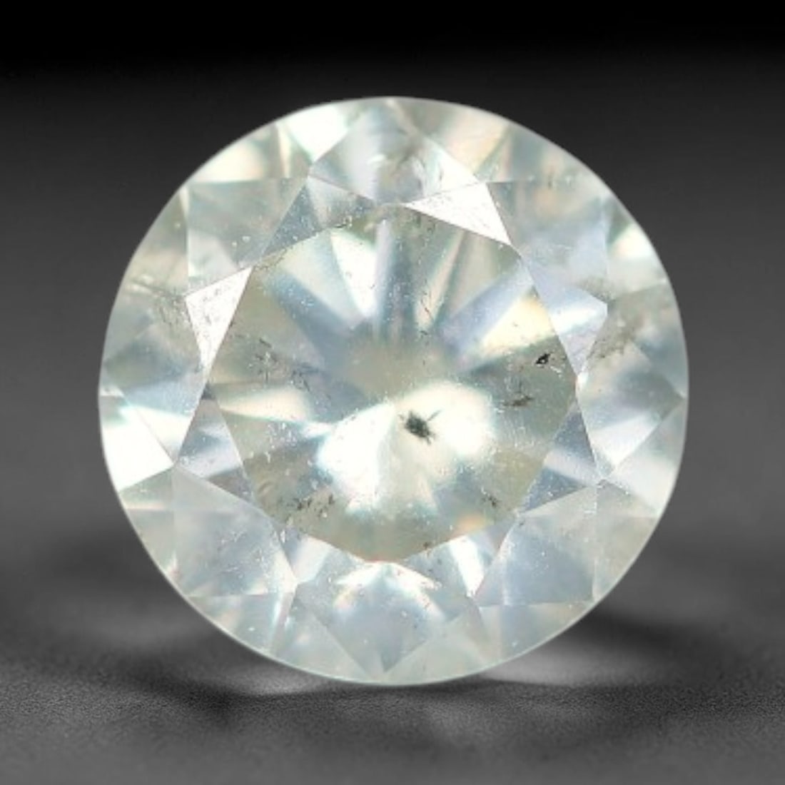 0.16ct Round Natural Fancy Greenish Yellow Diamond Loose Gemstone, 35BH: This polished natural round fancy diamond displays a delicate greenish-yellow base tone, with scattered fine native mineral specks distributed within its crystalline interior, measured at calibrated d