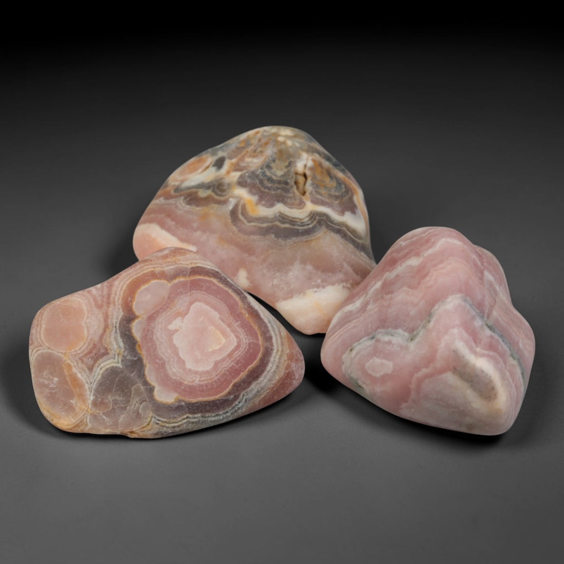 57ct 3pcs Natural Argentine Rhodochrosite Banded Tumbled Rough Set, 9FD: This listing features three individual tumbled rhodochrosite rough pieces sourced from Argentina Capillitas deposits, each showcasing distinct layered banding of soft rose pink, cream white and pale t