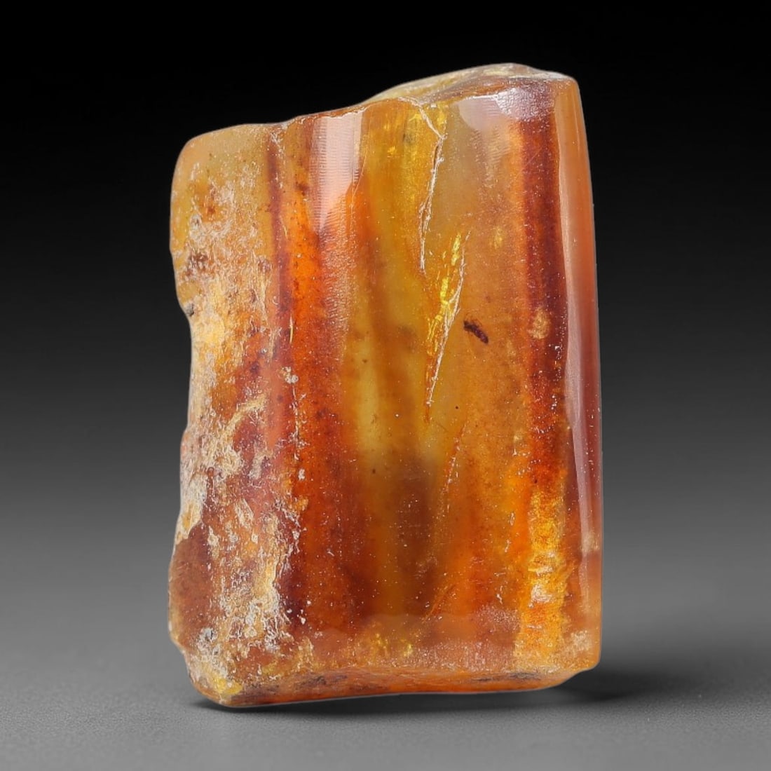 13.53ct Natural Baltic Polished Loose Freeform Amber Gemstone, 36EB: This smoothly polished freeform amber piece carries warm translucent organic clarity with fine natural fossil flecks and tiny mineral inclusions suspended throughout its 24x17mm flowing unstructured s