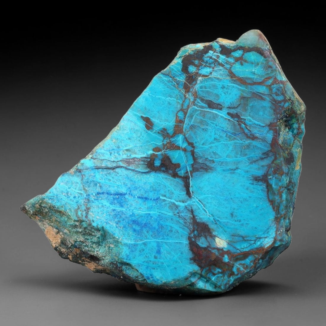 95ct Natural Peruvian Chrysocolla Polished Slab Rough, 66AR: This partial-polished chrysocolla slab features blended mineral matrix with smooth refined face and unaltered natural rugged edge across its 44x32x6mm elongated form, translucent mineral layers hold s