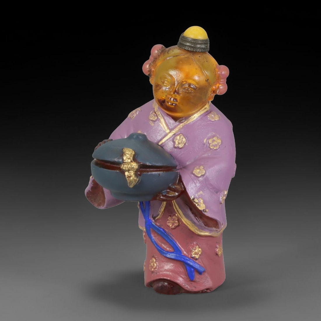 Vintage Chinese Liuli Glass Snuff Bottle - Child Holding Treasure Censer, 50AS: This snuff bottle is moulded from translucent amber liuli glass, formed as a standing child holding a covered censer with gilded ornament. The traditional robe is decorated with hand-painted gold flor