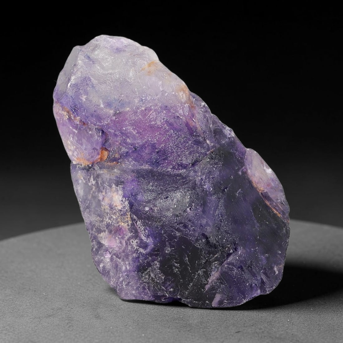 152ct Natural Chinese Deep Violet Purple Fluorite Rough, 2AT: This rugged fluorite rough boasts rich layered violet purple saturation blended with warm rust-colored mineral inclusions that streak its uneven raw surface, soft translucency lets light drift through