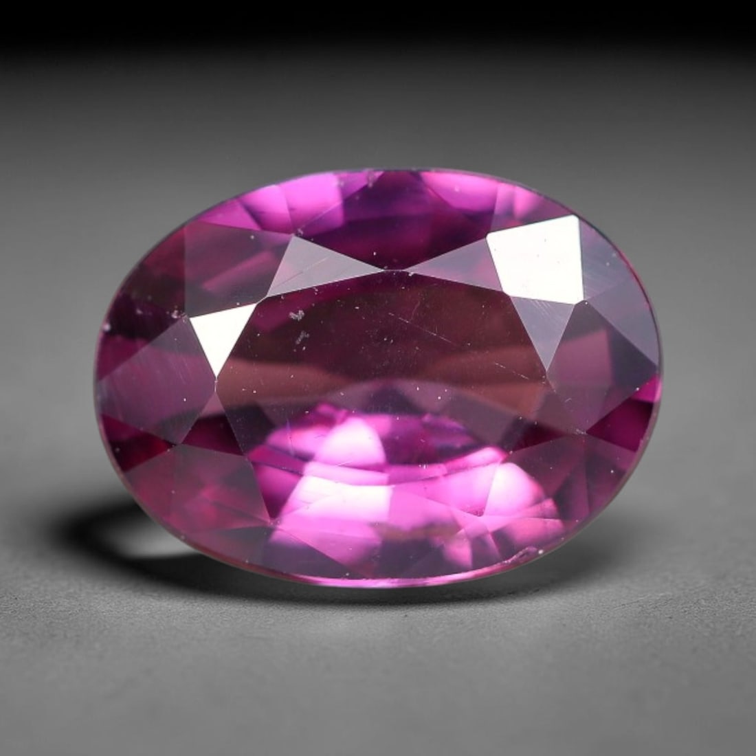 1.18ct Natural Tanzanian Rhodolite Grape Garnet Faceted Loose Gemstone, 6BE: This expertly faceted grape garnet, a scarce saturated purple-magenta rhodolite variant, features transparent crystal structure dotted with faint microscopic mineral specks within its precisely cut re
