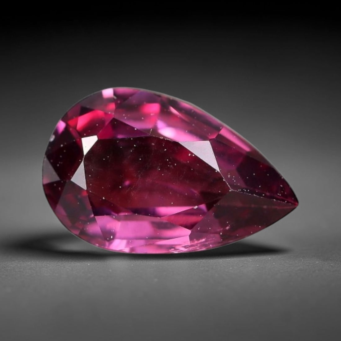 1.06 Carats Natural Mozambique Rich Raspberry Rhodolite Garnet Loose Gemstone, 51FM: This natural Mozambique rhodolite garnet holds dimension measurements of 8.4x5.5x2.8mm, carrying an intense saturated raspberry red hue that radiates vivid tonal flashes through its transparent crysta