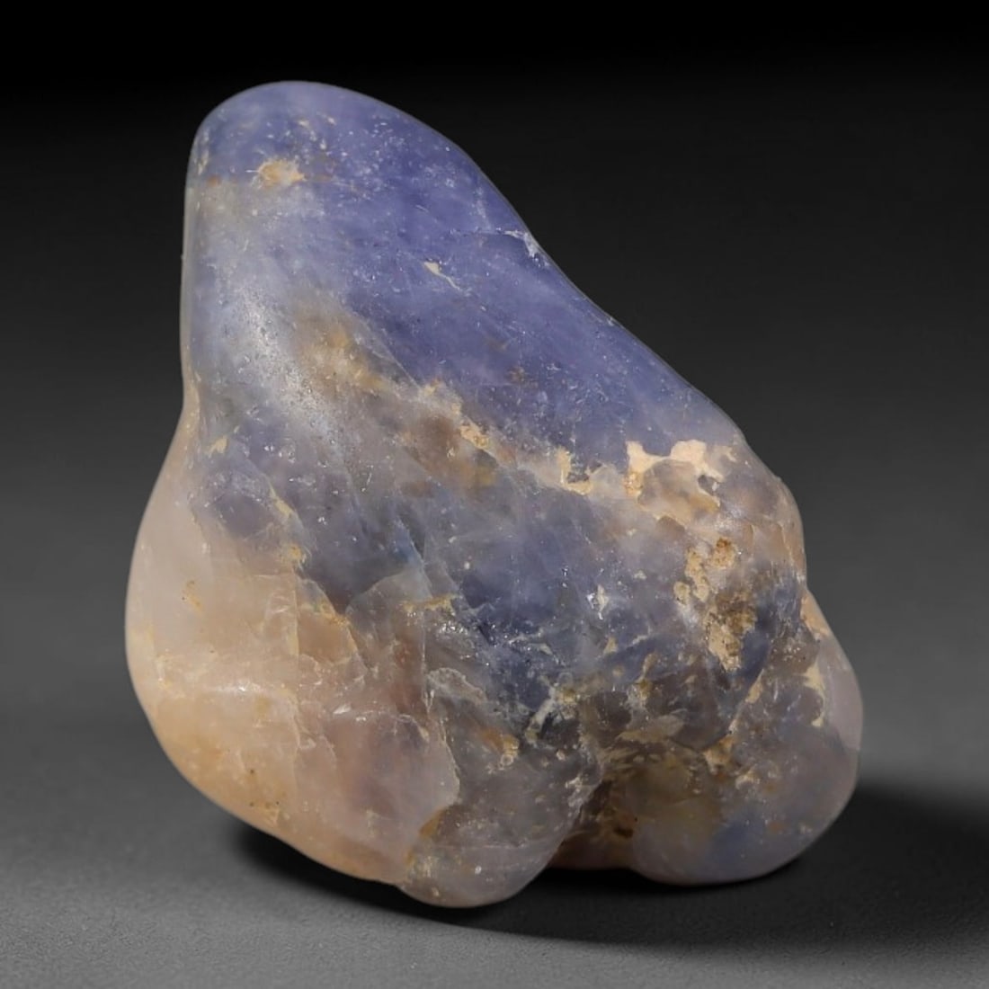24.88ct Natural Unheated Sri Lankan Purplish Blue Sapphire Rough, 72FC: This natural corundum rough is an unheated purplish blue sapphire sourced from Sri Lankan alluvial gem deposits, featuring an irregular natural native form with residual pale yellow-brown mineral matr