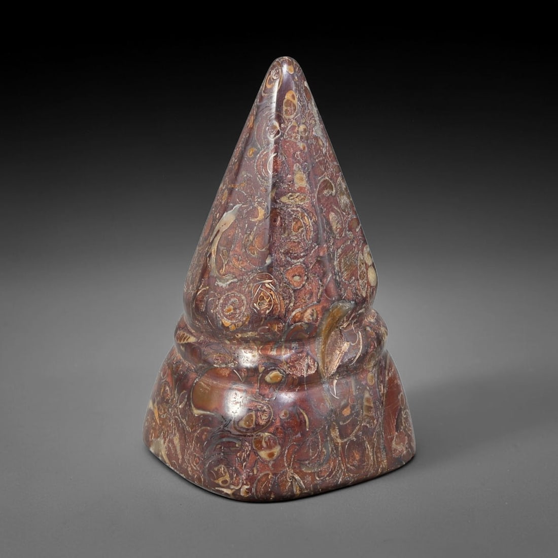 Ancient Medieval Mamluk Fossil Stone Conical Talisman (13th-16th Centuries CE), 39EF: This finely polished conical talisman is crafted from decorative fossil-bearing stone originating from the medieval Mamluk realm. The piece features a tiered base rising to a sharp tapered point, show