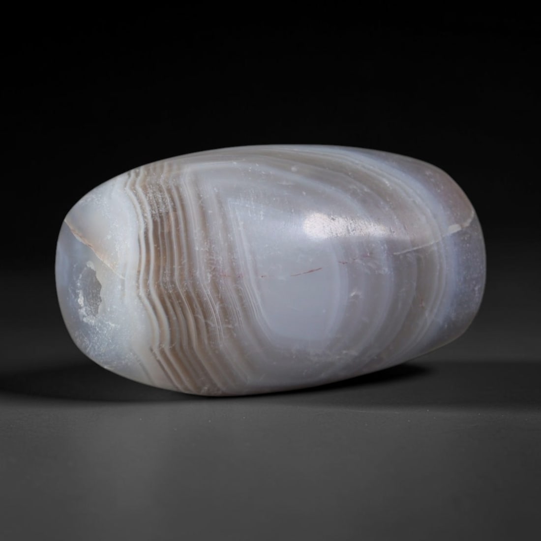 Ancient Babylonian & Kassite Cultures Banded Agate Barrel Bead (1900-600 BCE), 52AD: This antique banded agate barrel bead originates from the Babylonian & Kassite Cultures, prominent Mesopotamian civilizations that utilized banded agate beads as temple offerings and key components of
