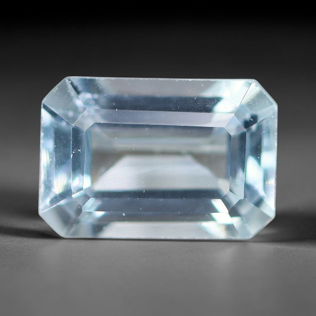 1.50ct Natural Brazilian Sky Blue Faceted Aquamarine Loose Gemstone, 11BF: This precisely faceted aquamarine boasts clear translucent pale sky blue body tone with subtle thin mineral needle and tiny scattered crystalline specks visible within its polished reflective planes i