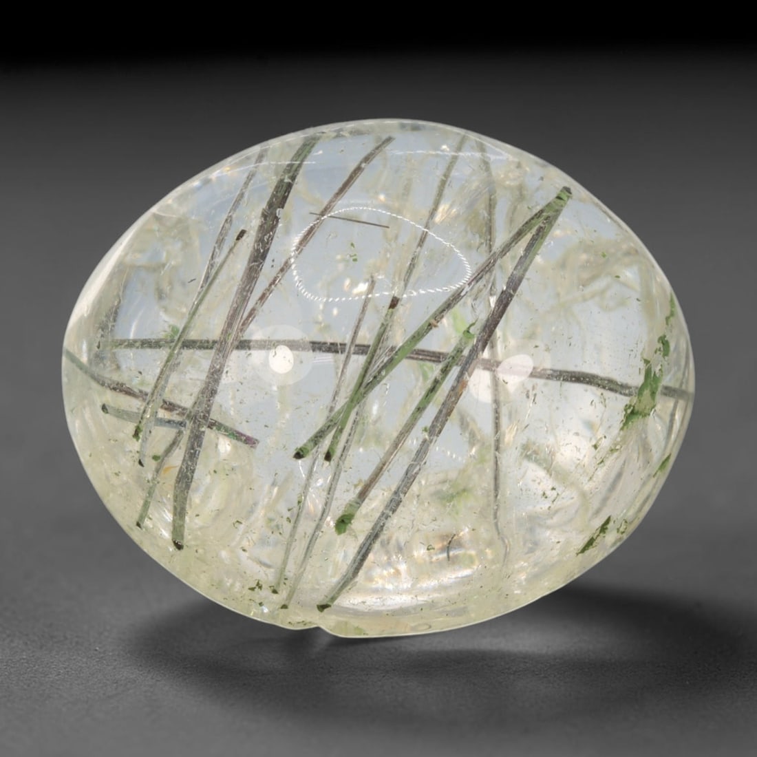 27ct Natural Brazilian Black Rutile Quartz Cabochon Loose Gemstone, 40BM: This polished cabochon of natural rutile quartz features countless distinct slender black rutile needle inclusions suspended within the clear quartz host crystal. The smooth domed surface enables full