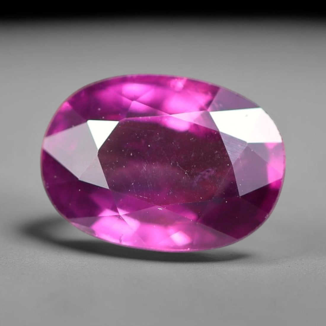 1.18ct Natural Tanzanian Rhodolite Grape Garnet Faceted Loose Gemstone, 4BE: This expertly faceted grape garnet, a scarce saturated purple-magenta rhodolite variant, features transparent crystal structure dotted with faint microscopic mineral specks within its precisely cut re
