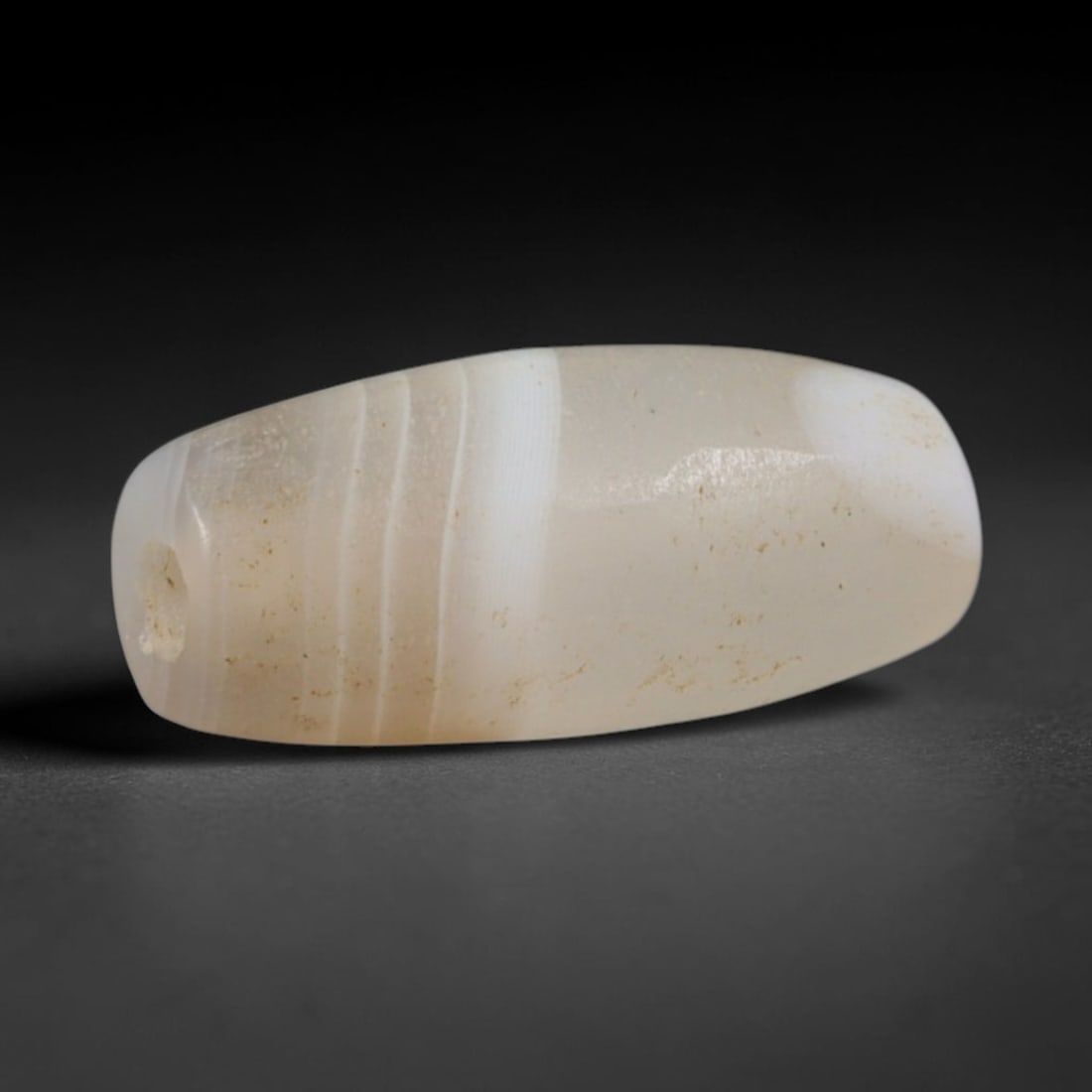 Ancient Scythian / Saka Steppe Nomad Cultures Banded Agate Barrel Bead (900-200 BCE), 5AD: This antique banded agate barrel bead originates from the Scythian / Saka Steppe Nomad Cultures, Eurasian steppe peoples who carved banded agate beads for elite burial regalia and personal nomadic ado