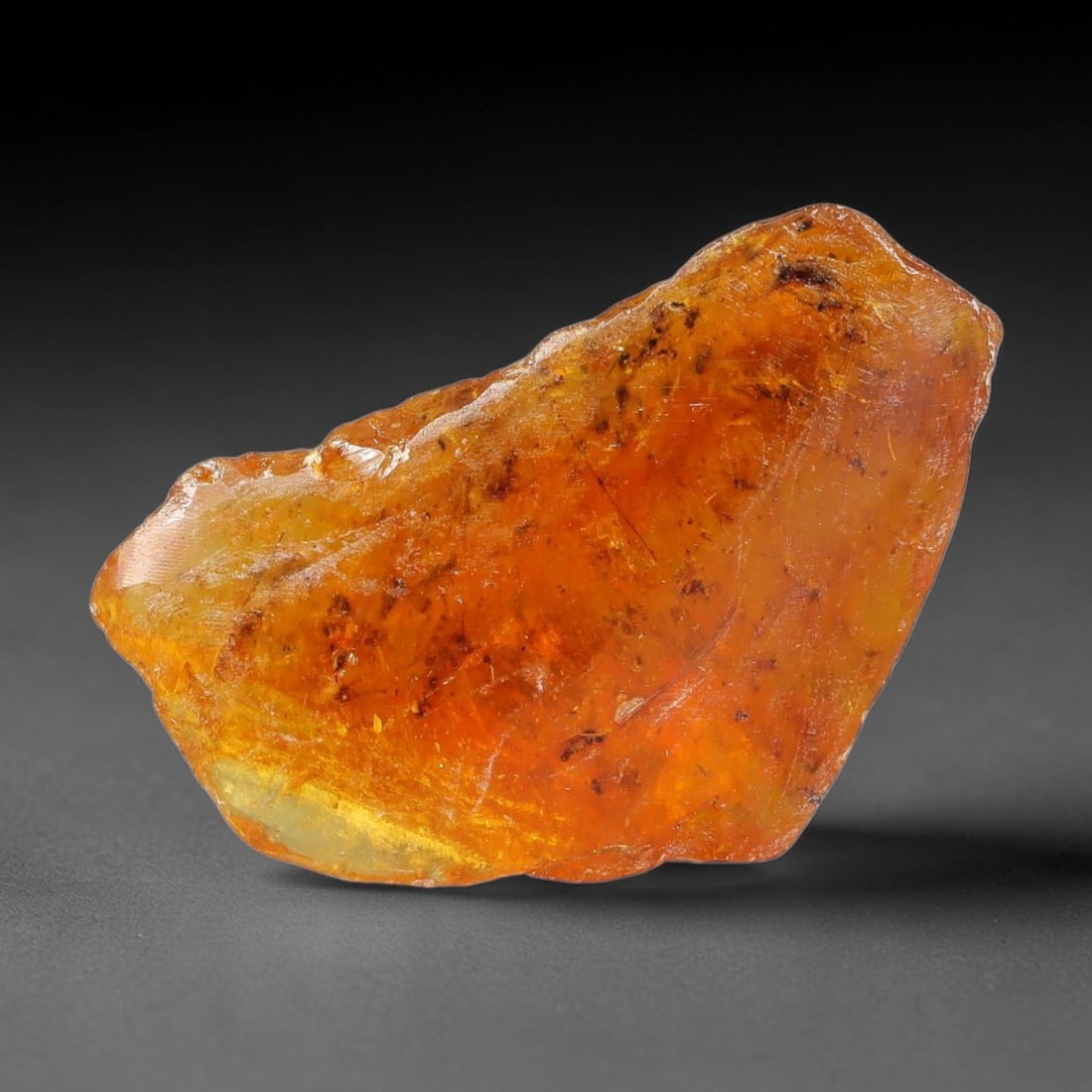 12.30ct Natural Baltic Polished Loose Freeform Amber Rough, 17EK: This smoothly polished freeform amber piece carries warm translucent organic clarity with fine natural fossil flecks and tiny mineral inclusions suspended throughout its 29x18x10mm flowing unstructure