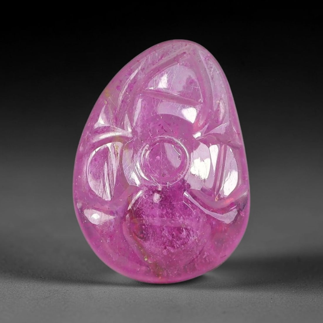 6.29 Carats Natural Mozambique Rich Fuchsia Ruby Loose Gemstone, 42FE: This natural Mozambique ruby cabochon measures 14.5x10.6x3.5mm and features delicate hand engraved floral detailing carved across its polished surface, with a rich saturated fuchsia hue spread evenly 