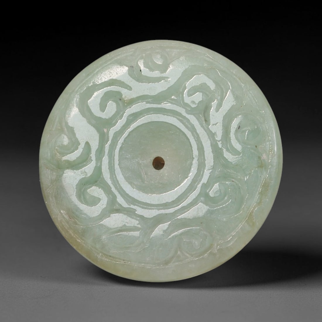 Natural Burmese Type A Jadeite Jade Carved Disc Pendant, 59BP: Artisan hand-carved untreated Burmese Type A jadeite jade circular disc pendant with a 27 mm diameter. The surface is adorned with detailed traditional relief carving finished with a smooth polished s
